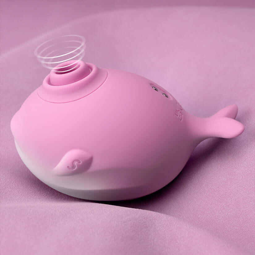 Tracys Dog Whalo Air Suction Massager in sleek pink design on soft fabric.