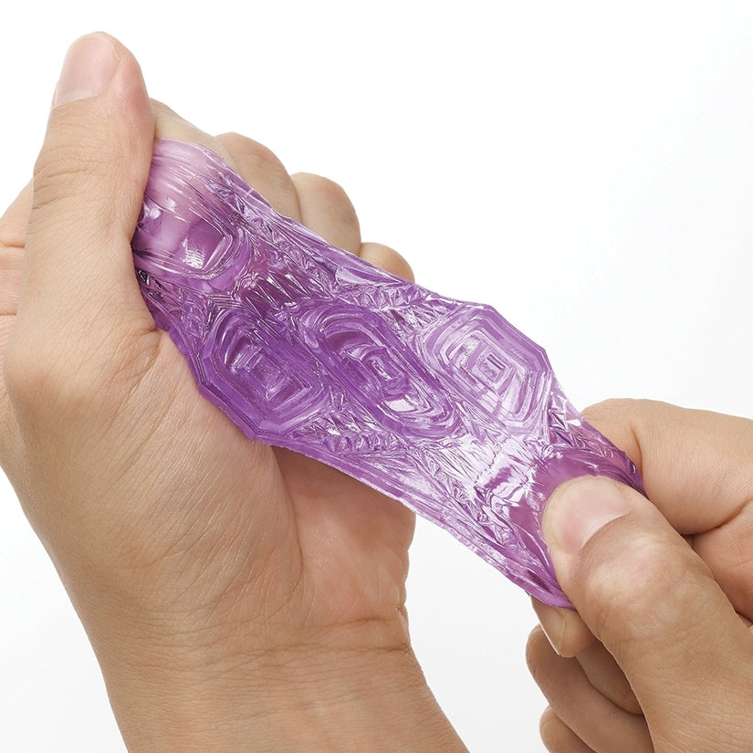 Tenga Uni Variety Pack of 4 Masturbators being squeezed to showcase its stretchy texture and design.