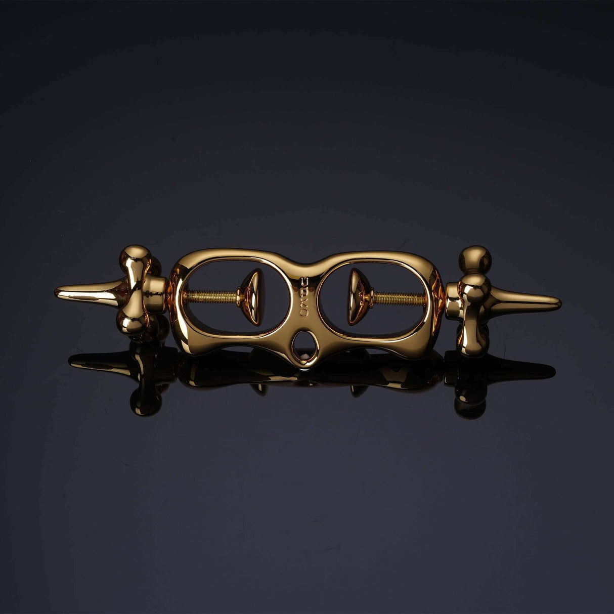 UPKO Thumb Metal Cuffs in gold, featuring a unique string mechanism for secure and discreet restraint play.