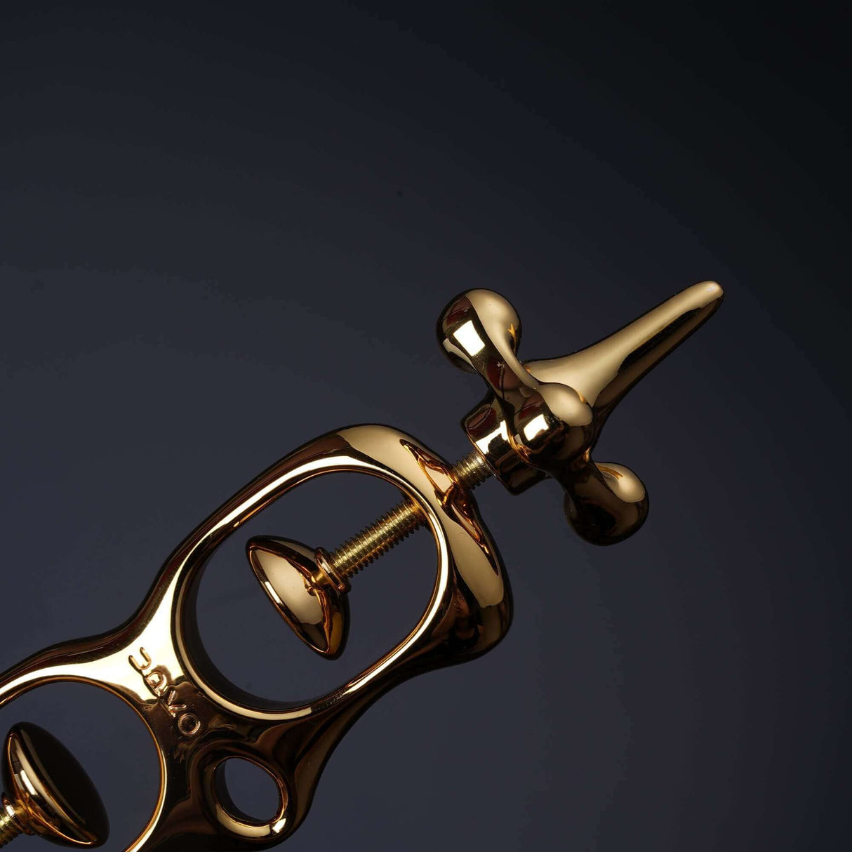 Close-up of UPKO Thumb Metal Cuffs showcasing the sleek gold design and unique mechanism for secure restraint.