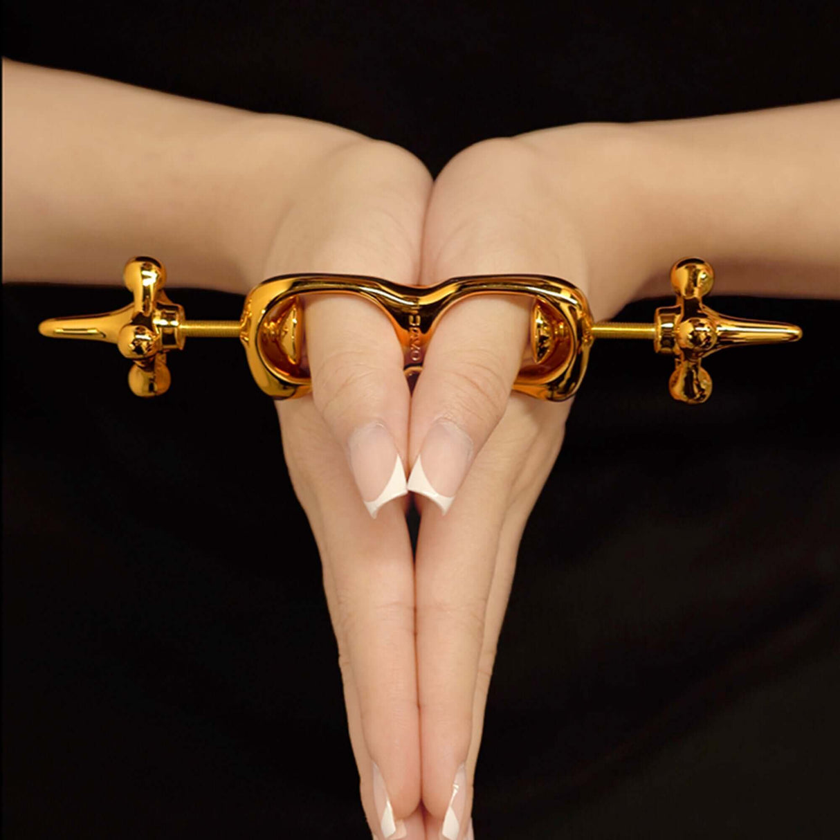 UPKO Thumb Metal Cuffs showcasing a sleek design clasping fingers together for discipline play.