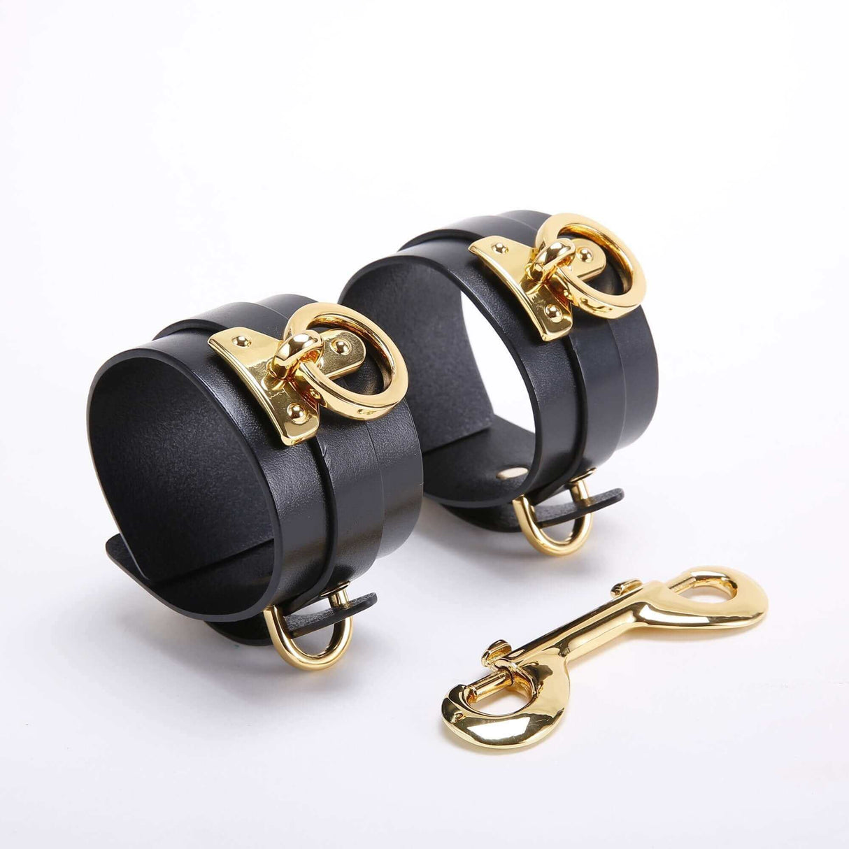 UPKO black leather wrist cuffs with gold hardware, part of the luxury bondage tools set for BDSM play.