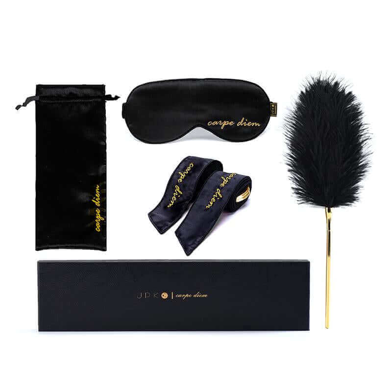 Carpe Diem Premium Silk Bondage Set by UPKO featuring a silk blindfold, satin ribbons, feather tickler, and storage bag.