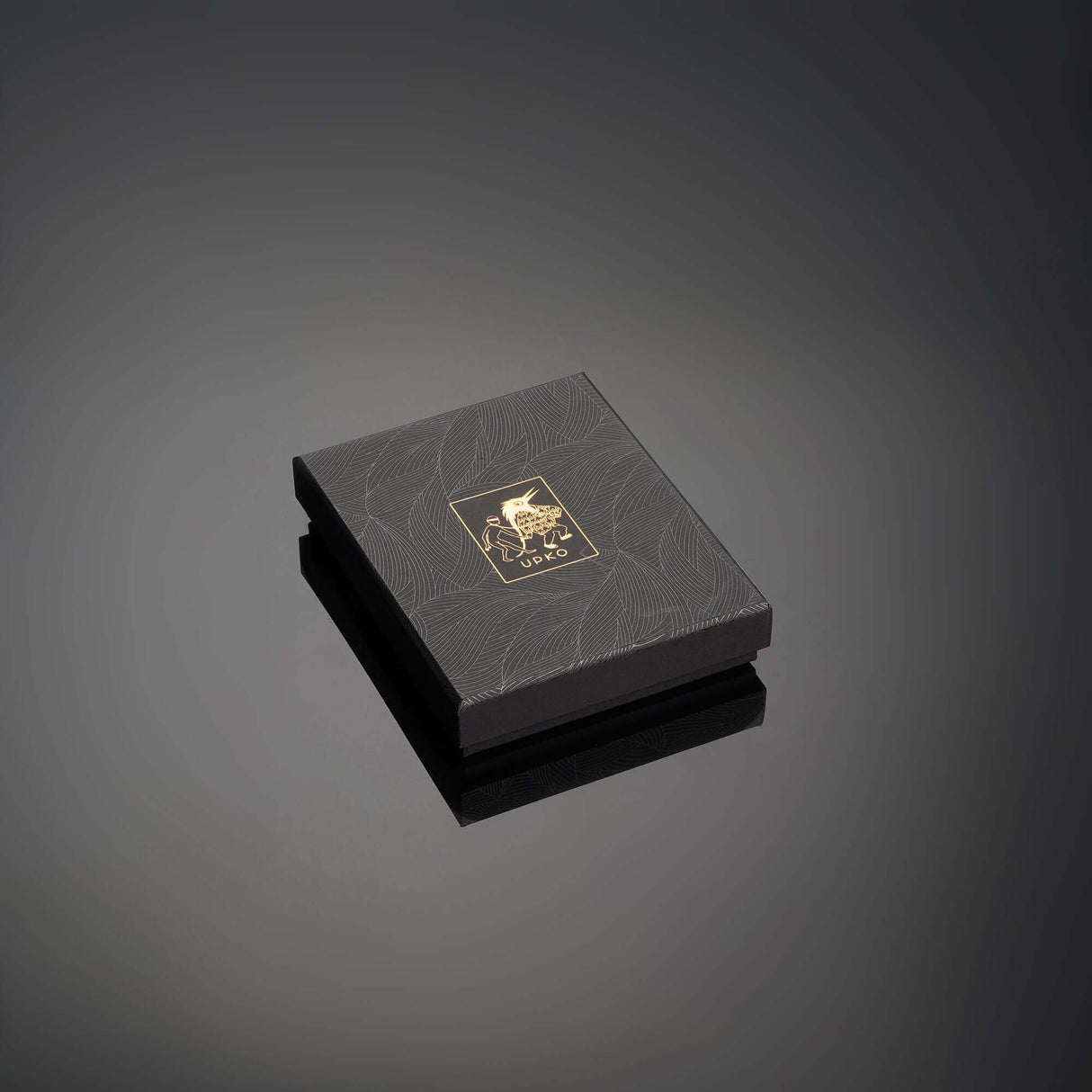 Elegant black jewel box for UPKO Water Chiming Bells non-pierced clitoral jewelry, featuring gold embossed logo on the lid.