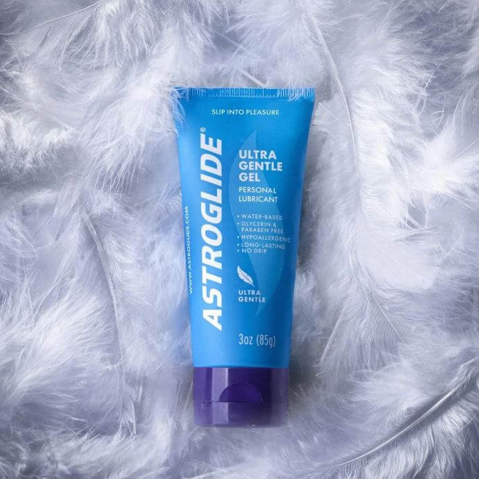 Astroglide Water Gel 3 Oz Water-Based Lubricant in a blue tube on soft feathers.