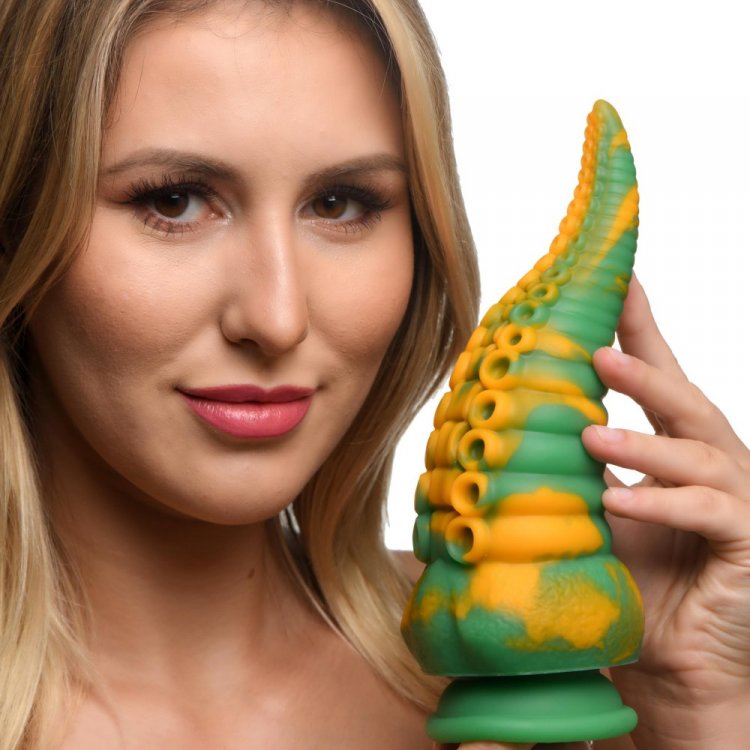 Woman holding the Creature Cocks Monstropus Tentacled Monster Dildo featuring unique marbled design and tapered shape.