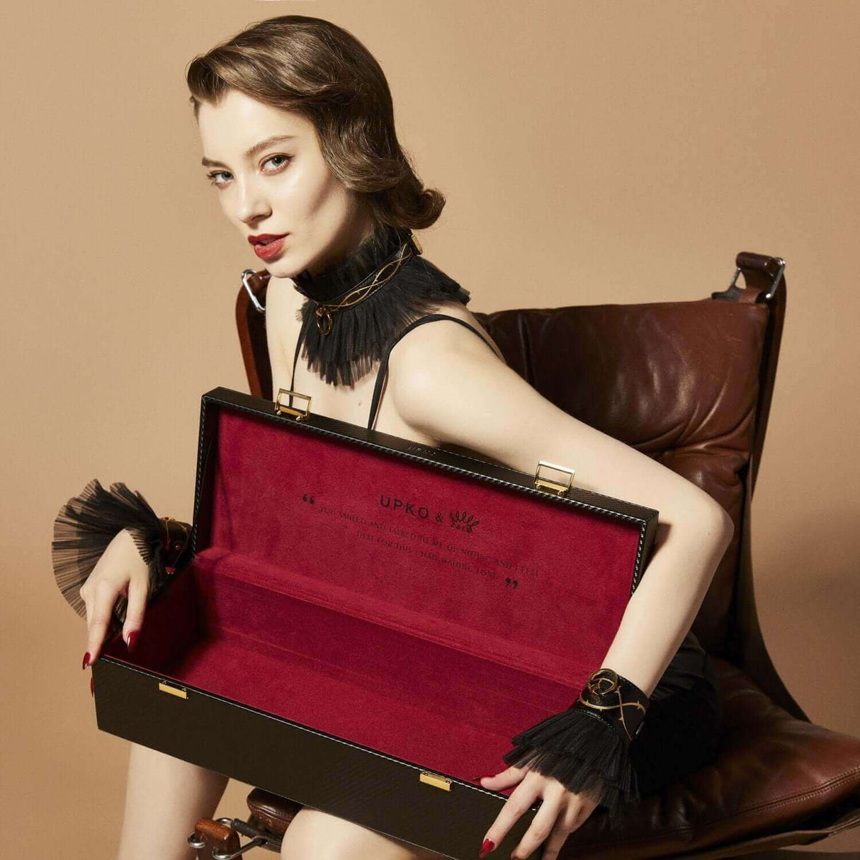 Woman showcasing the luxurious open storage case from ZALO & UPKO Doll Designer Collection Bondage Play Kit.