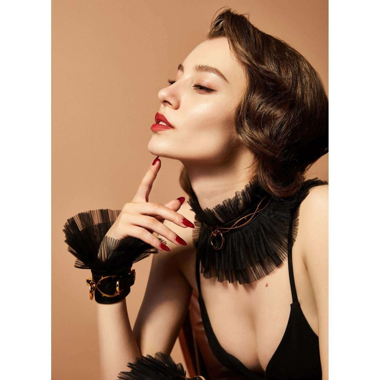 Woman wearing black leather thorn collar and handcuffs from ZALO & UPKO Doll Designer Collection, exuding luxury and elegance.