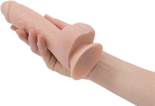 Addiction 100% Silicone Mark realistic dildo in a hand, showcasing its detail and strong suction cup for hands-free play.