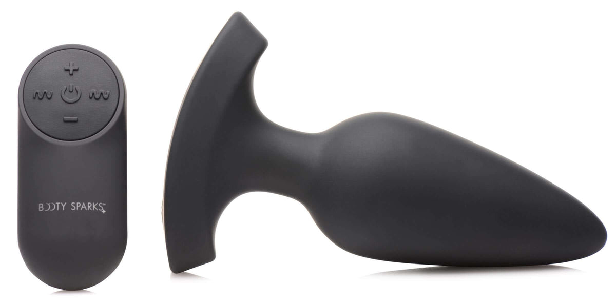 28X Laser Heart Silicone Anal Plug with Remote Large next to its remote control.