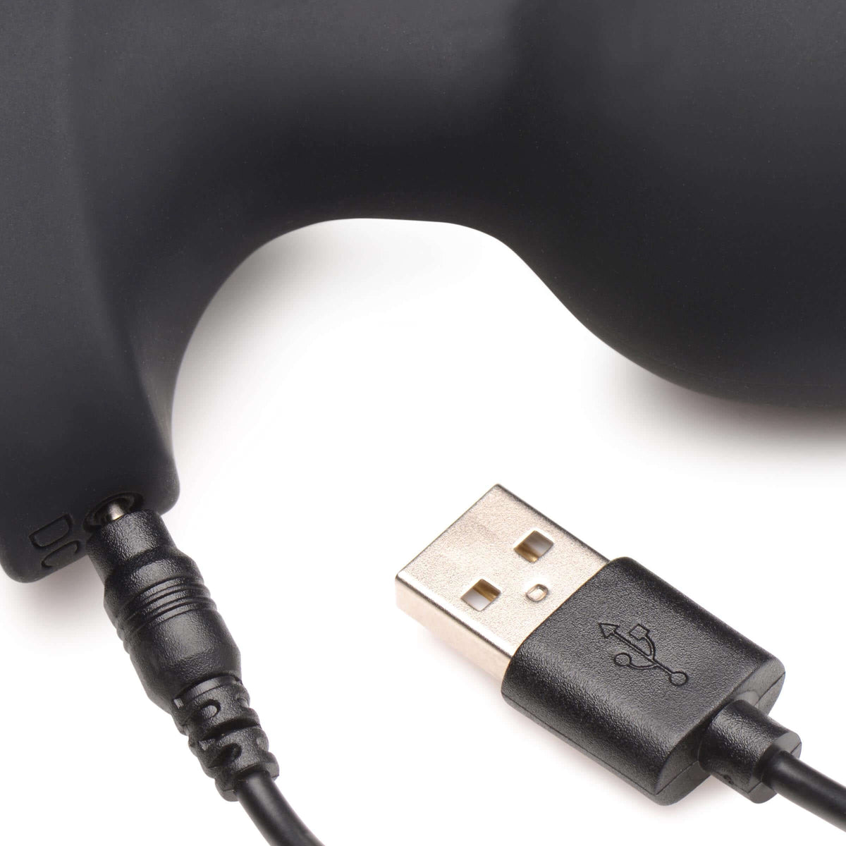 Close-up of the charging connector for the 28X Laser Heart Silicone Anal Plug with Remote Large.