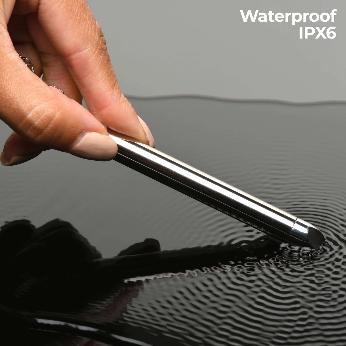 Charmed 7X Vibrating Necklace Silver being demonstrated in water, highlighting its waterproof IPX6 feature.