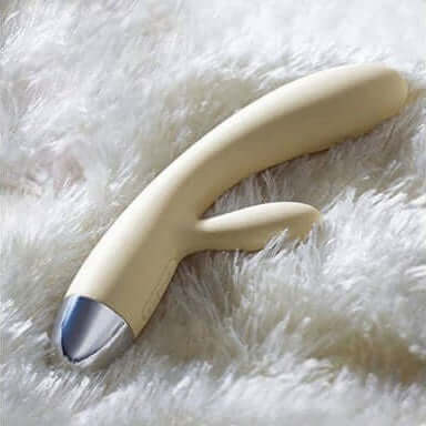 Alice Rabbit Vibrator Khaki by Svakom, a sleek silicone sex toy on a soft surface.