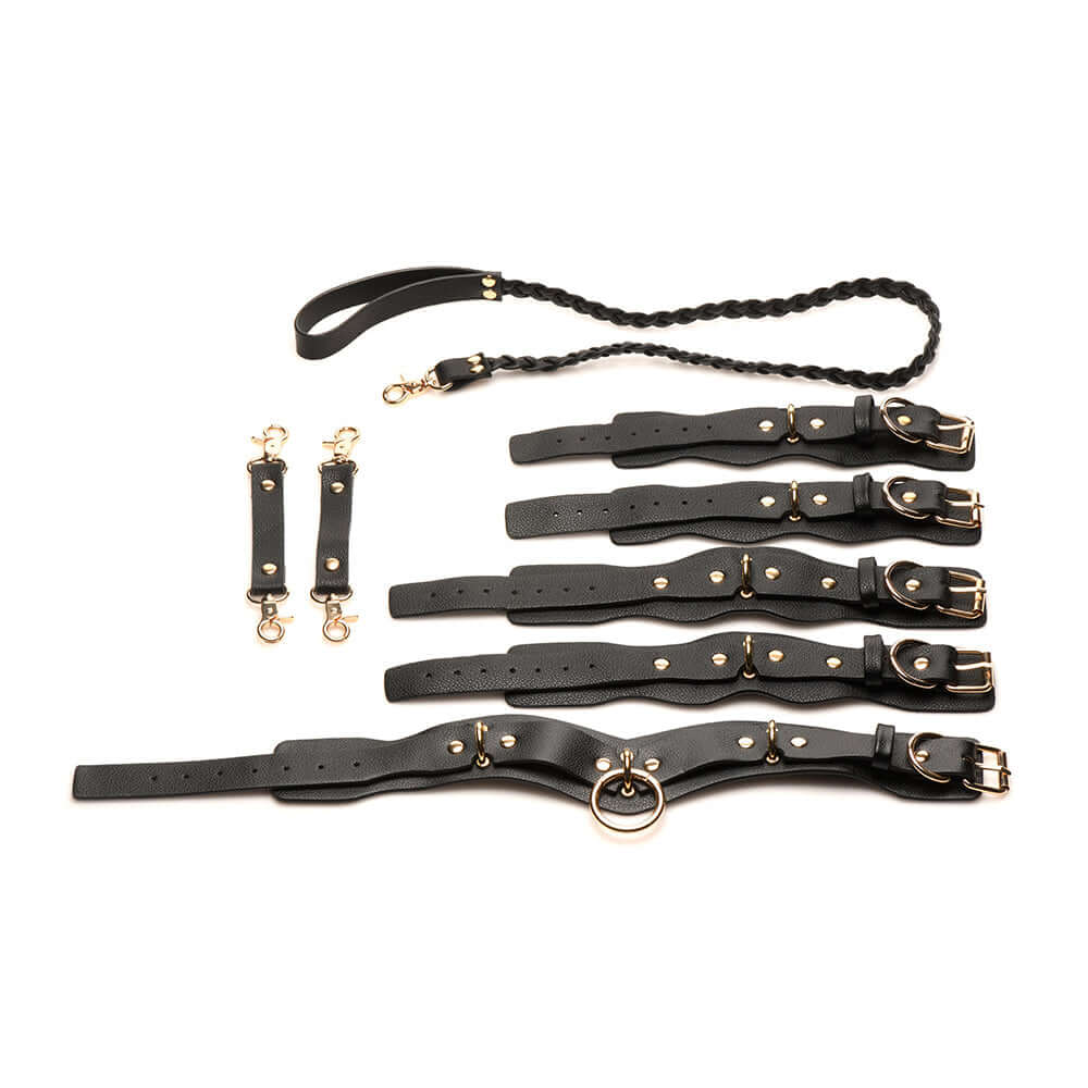 Bedroom Bliss Lover's Restraints Set in black vegan leather with cuffs, collar, leash, and connectors for intimate fun.