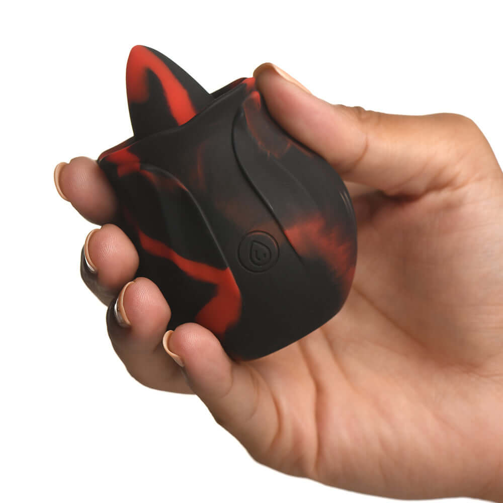 A person holding the Bloomgasm Black Kiss Rimming Rose, a silicone tongue-shaped toy designed for intimate pleasure.