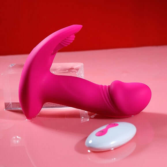 Litty Clitty Remote Control Wearable Vibrator on a pink surface with remote control for discreet pleasure.