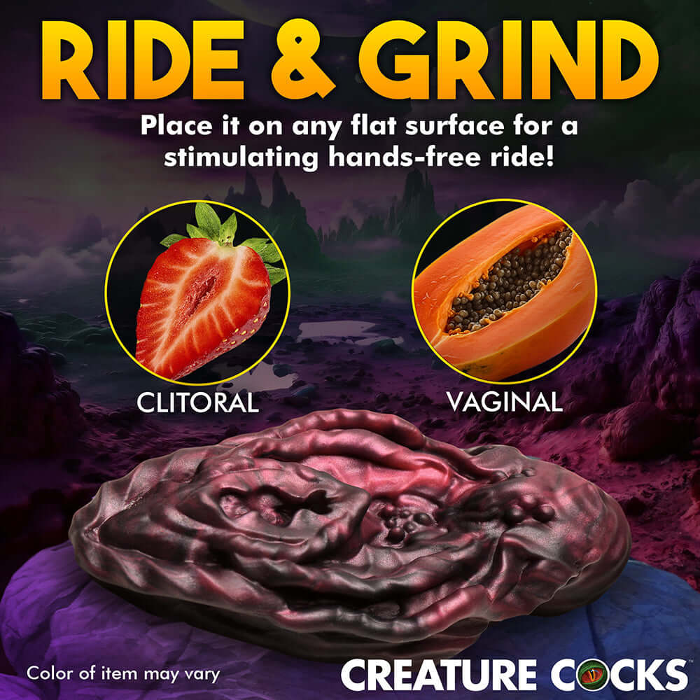 Creature Cocks Ride & Grind silicone toy for hands-free clitoral and vaginal stimulation against a cosmic background.