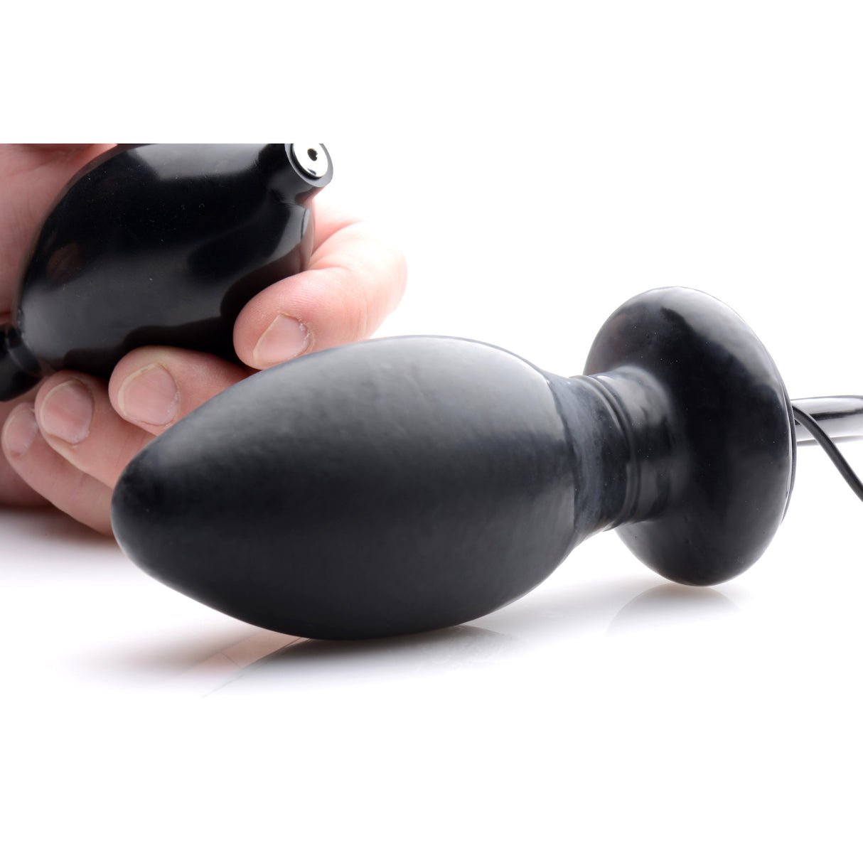 Vibro Inflatable Anal Plug Black being held, showcasing its inflatable and vibrating features for intense anal pleasure.
