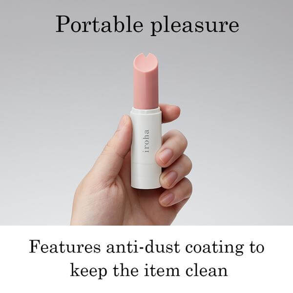 Tenga Iroha Stick Vibrator Light Pink White in hand, showcasing its portable design and anti-dust coating.