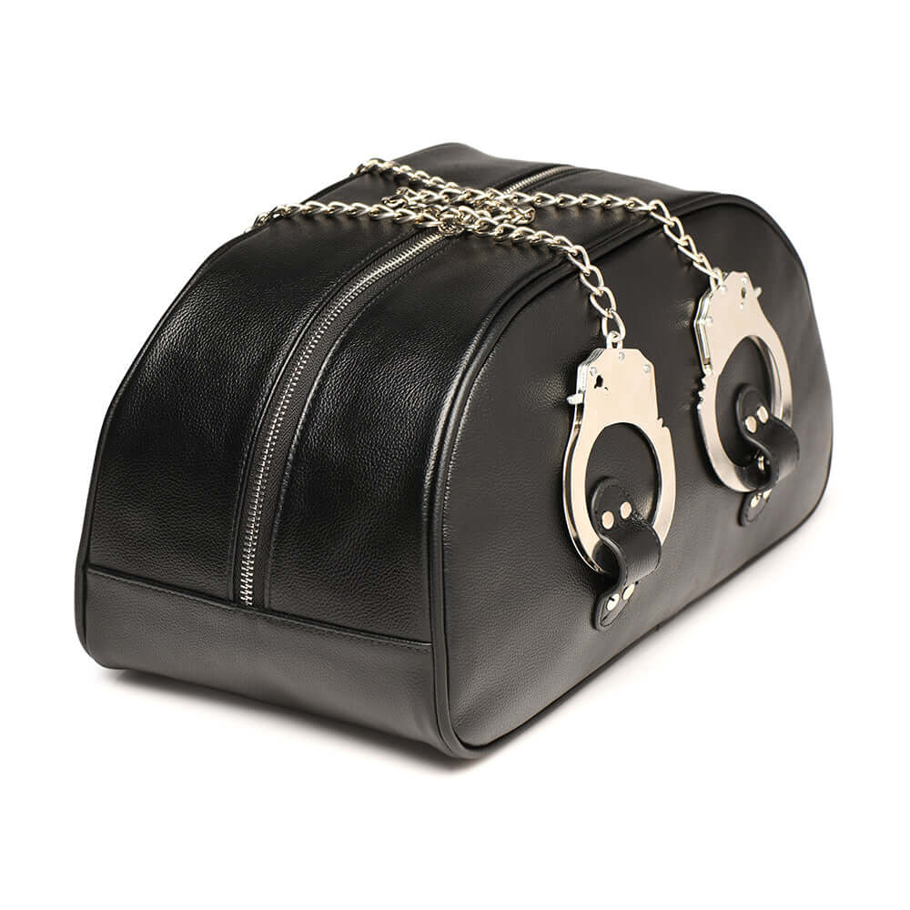 Master Series cuffed travel bag in faux leather with handcuff handles, perfect for stylish overnight stays.