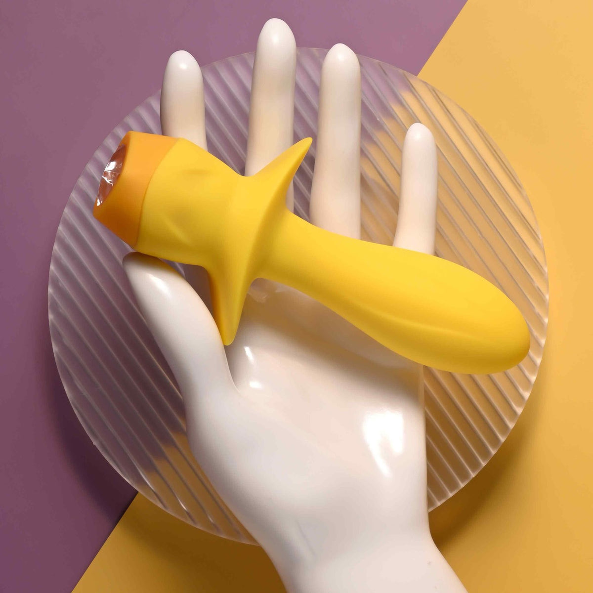 Selopa Mellow Yellow Silicone Vibrating Plug Yellow held in a hand, showcasing its bright color and unique design.