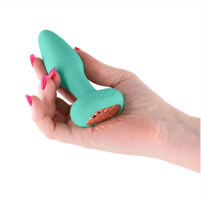 Techno Prism Silicone App Compatible Anal Plug Teal held in hand with vibrant teal silicone finish and vibrating feature.