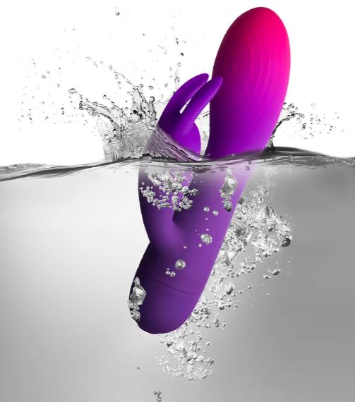 Rocks Off Glo-girl Rabbit Vibrator Pink Purple submerged in water, showcasing vibrant colors and waterproof features.