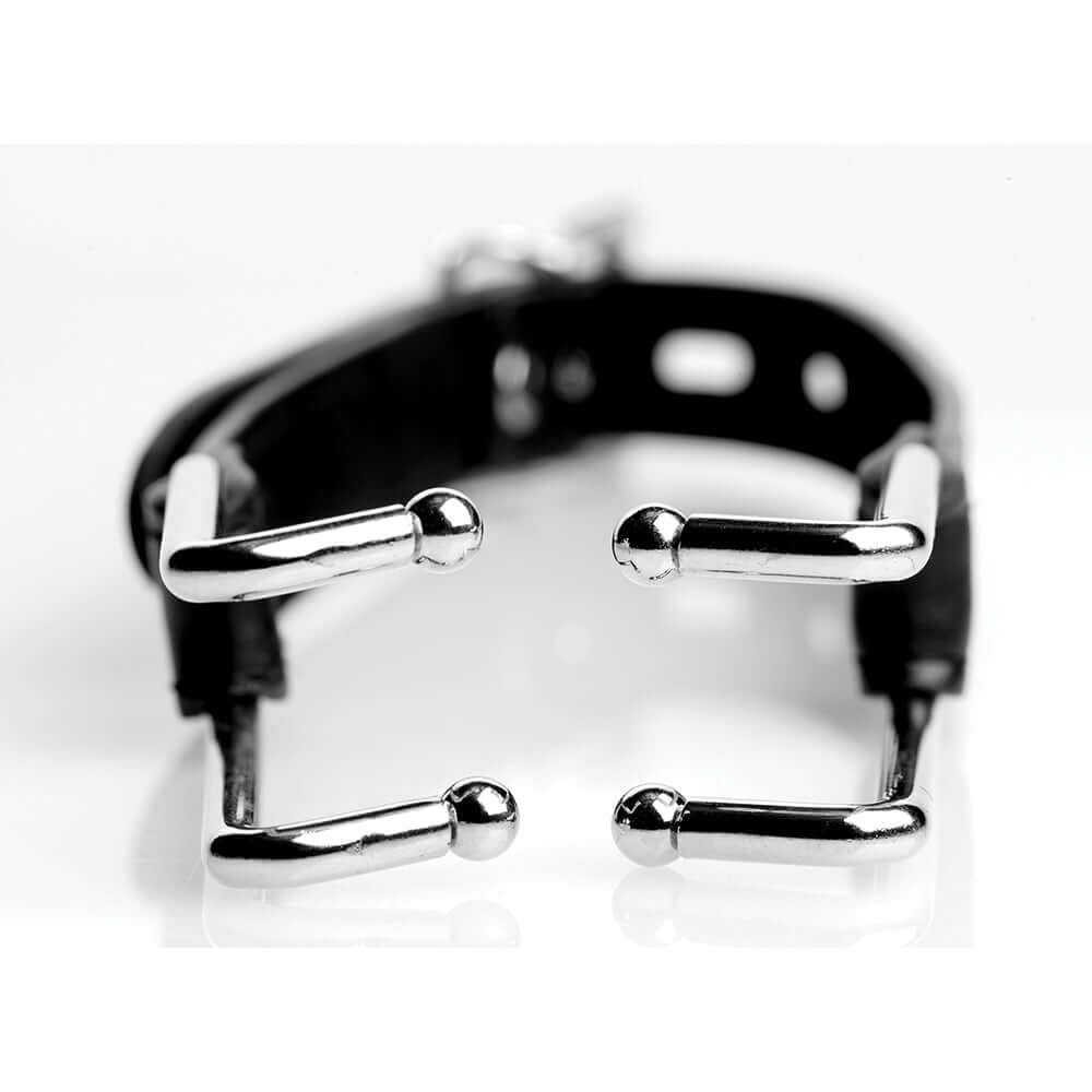 Close-up of the STRICT Claw Hook Mouth Spreader with shiny metal claws and black strap design.