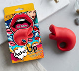 Pucker Up Lips With Ergonomic Finger Hold Red Vibrator next to its colorful packaging on a flat surface.
