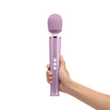 Le Wand Dive Submersible Vibrating Massager Lavender held in hand with purple design and control buttons.