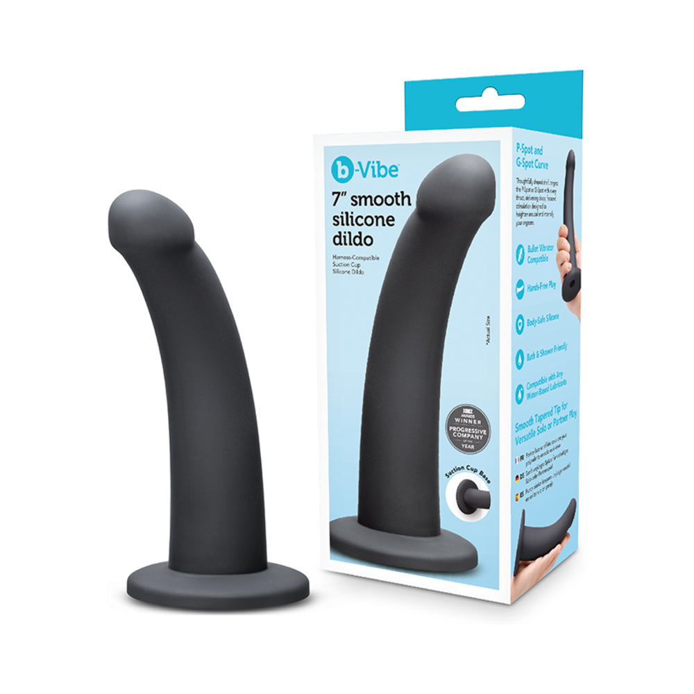 B-Vibe Essentials 7 Inch Smooth Silicone Dildo Black on display with packaging, showcasing its sleek design and smooth finish.