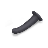 B-Vibe Essentials 7 Inch Smooth Silicone Dildo Black on a white background for a sleek and modern look.