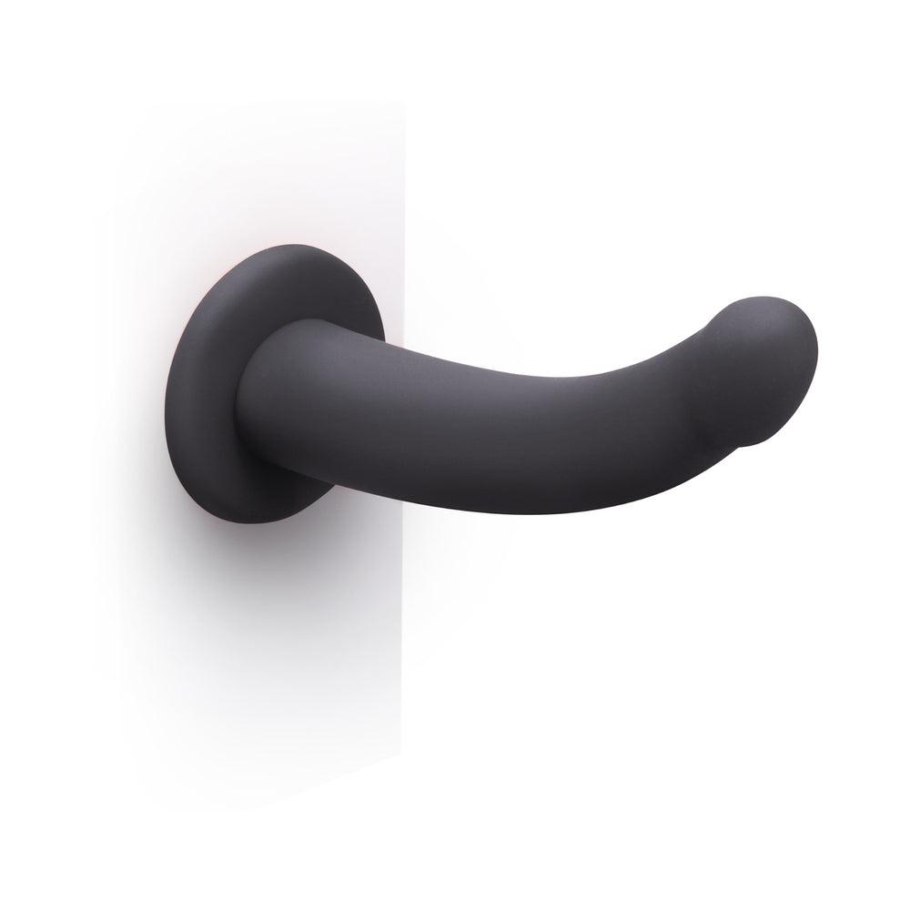 B-Vibe Essentials 7 Inch Smooth Silicone Dildo Black displayed on a white background showcasing its sleek design.