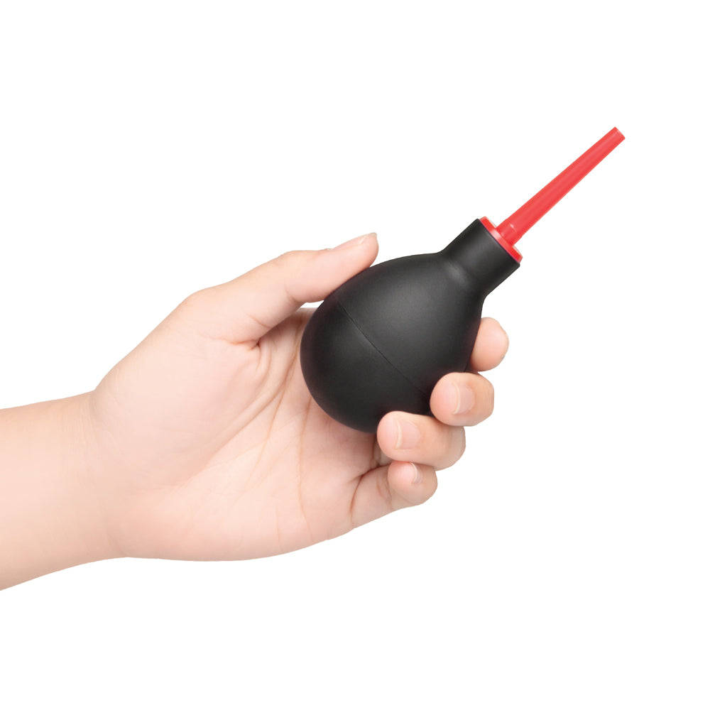 B-vibe Essentials Mini Travel Enema Set 30 Ml, compact anal douche held in hand for hygiene and travel.