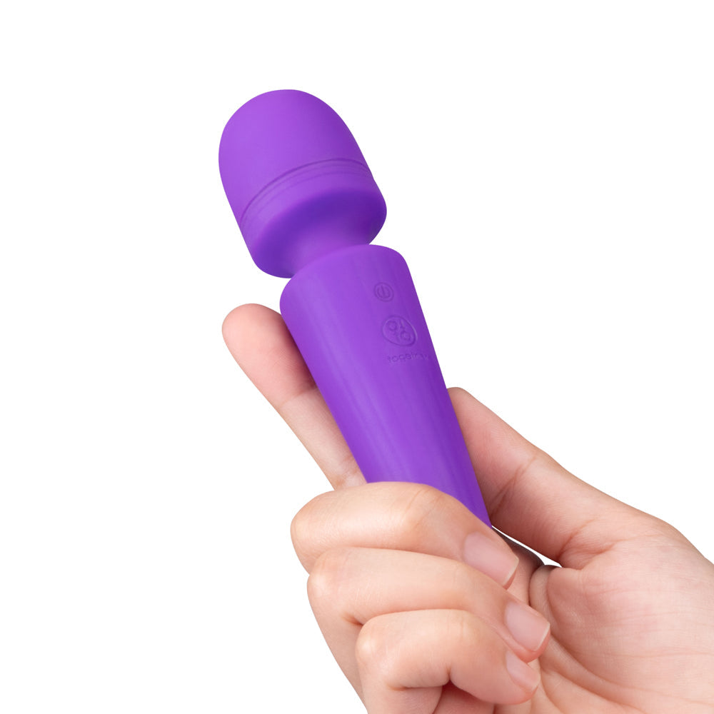 Together Glow On The Go Mini Wand Vibrator Purple held in hand showcasing its compact design.
