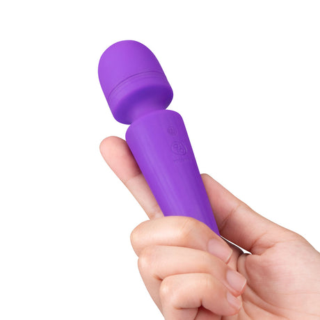 Together Glow On The Go Mini Wand Vibrator Purple held in hand showcasing its compact design.