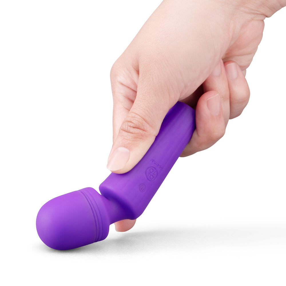 Together Glow On The Go Mini Wand Vibrator Purple held in hand, showcasing its compact design and vibrant color.