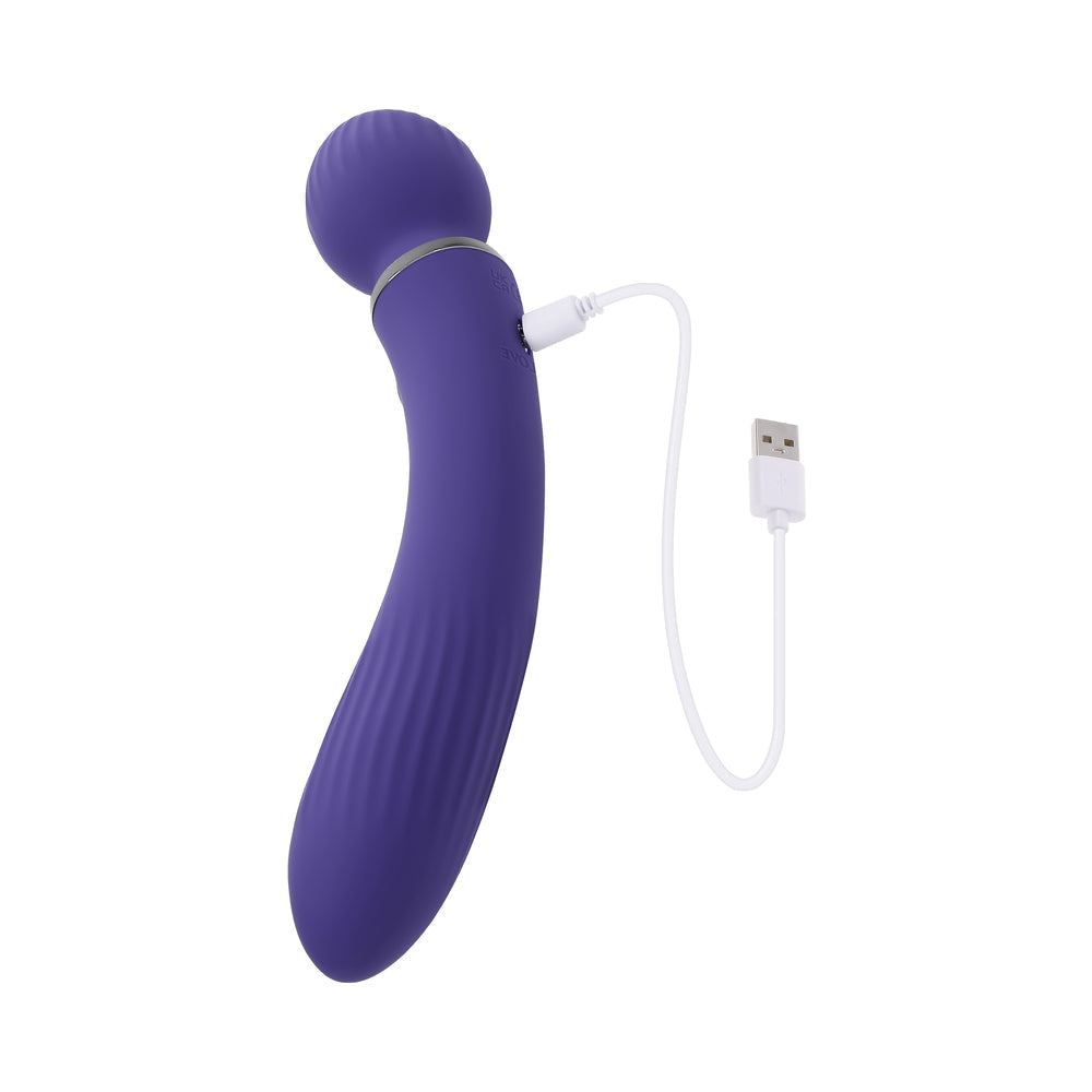Evolved Shiver Silicone Rechargeable Vibrator Purple charging with USB cable.