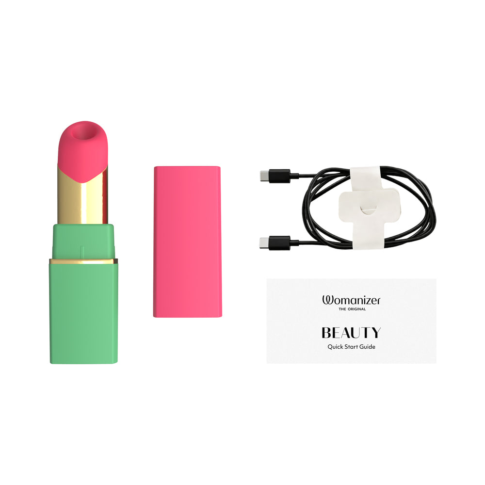 Womanizer Beauty Clitoral Stimulator Green Pink with charging cable and quick start guide.