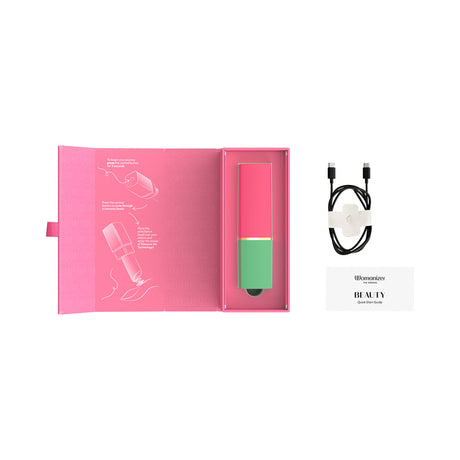 Womanizer Beauty Clitoral Stimulator Green Pink in packaging with guide and charger, designed for discreet pleasure.
