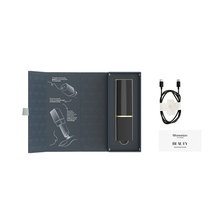 Womanizer Beauty Air Pulse Stimulator Black & Gold in elegant packaging with quick start guide and charging cable.