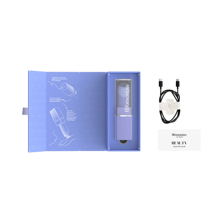 Womanizer Beauty Lilac Clitoral Air Pulse Stimulator packaging with quick start guide and charging cable.