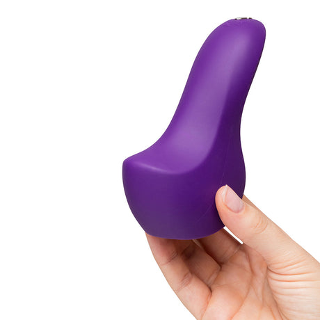 We-Vibe Shared Touch Couples Grinding Vibrator Purple held in hand, showcasing its ergonomic design and vibrant color.