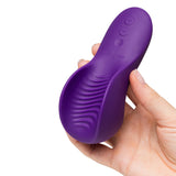We-Vibe Shared Touch Couples Grinding Vibrator Purple held in hand, showcasing its textured design and controls.