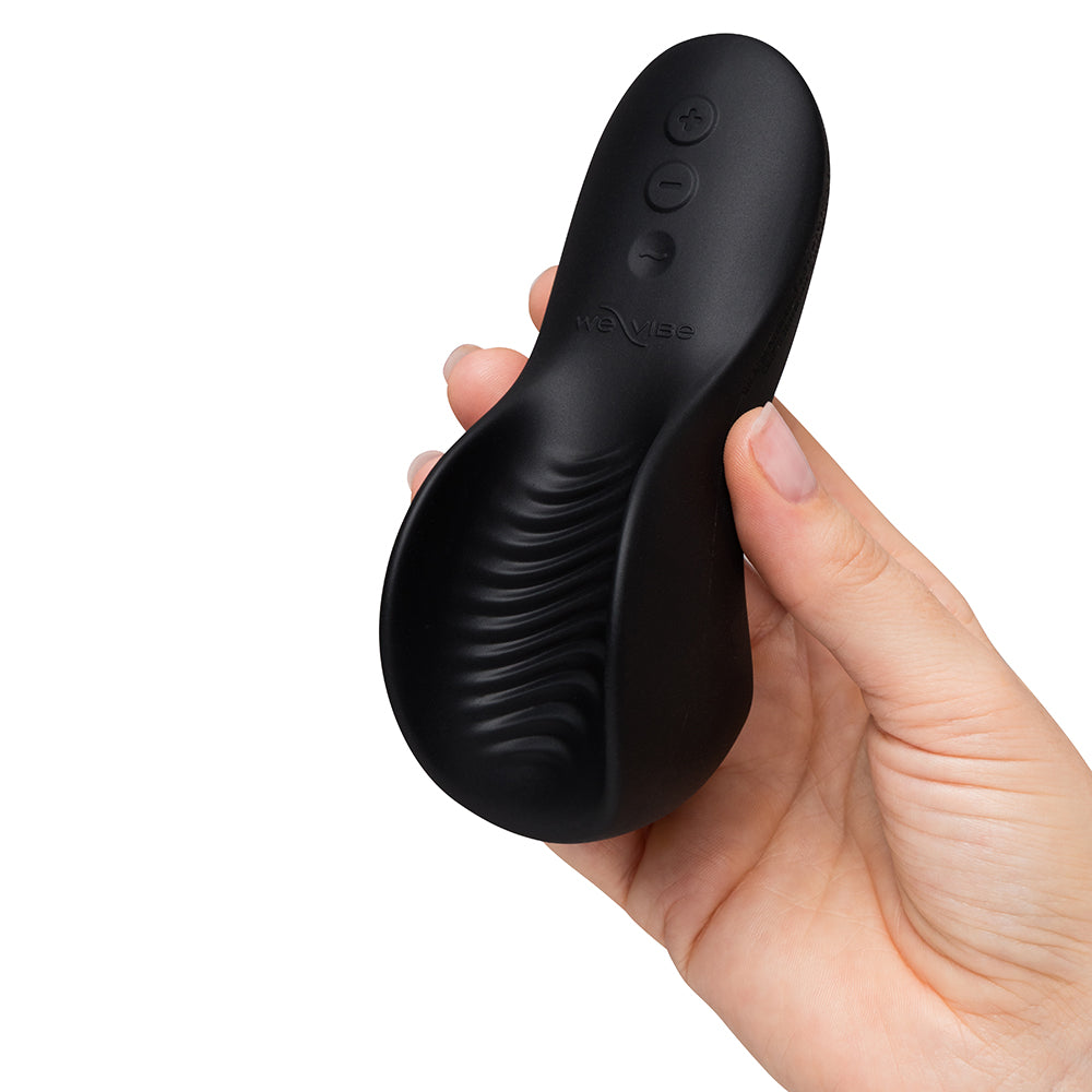 We-Vibe Shared Touch Rechargeable Vibrator Black held in hand showcasing its sleek design.