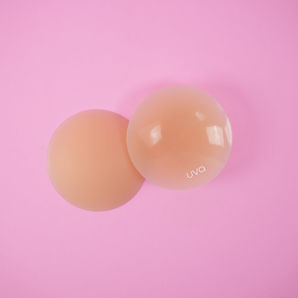 UVA Caramel Non-Adhesive Round Nipple Covers on a pink background for natural-looking coverage.
