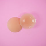 UVA Caramel Non-Adhesive Round Nipple Covers on a pink background for natural-looking coverage.