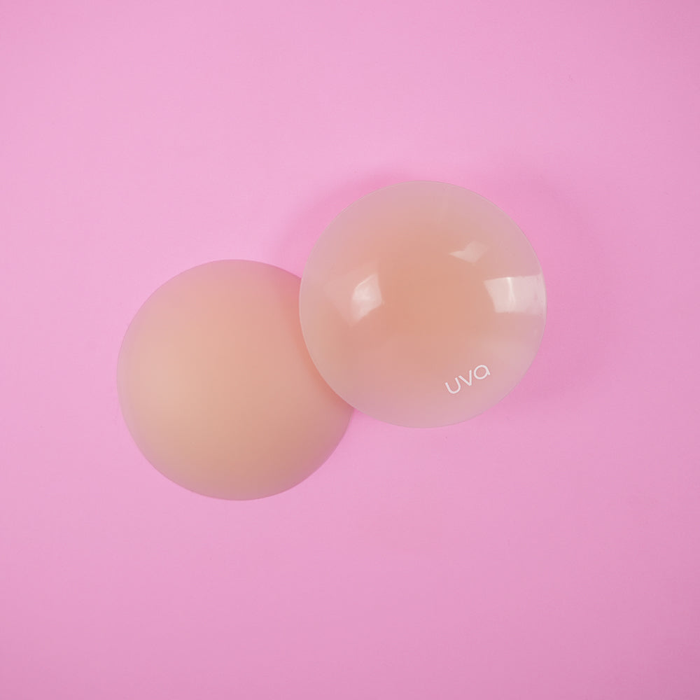 UVA Vanilla Non-Adhesive Round Nipple Covers displayed on a pink background, showcasing their seamless design.