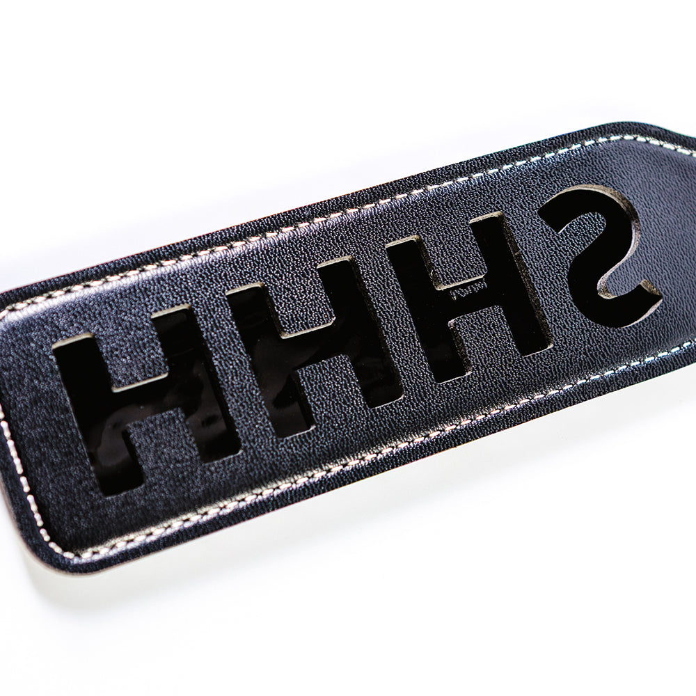 Sei Mio Double Trouble Shhh Oops Double-Sided Paddle showcasing the playful 'SHHH' design in a stylish black finish.