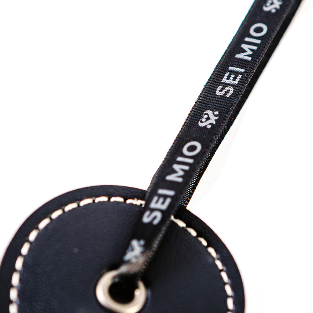 Close-up of the Sei Mio Double Trouble Shhh Oops Double-Sided Paddle showing the elegant branding.